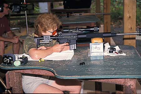 Photograph of Suzanne shooting her custom-made AR-15 match rifle.